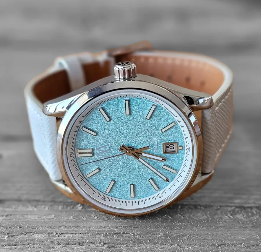 Official Meshberg image of the Arctic Sky 37 mm automatic with an icy blue textured dial and light gray leather strap.